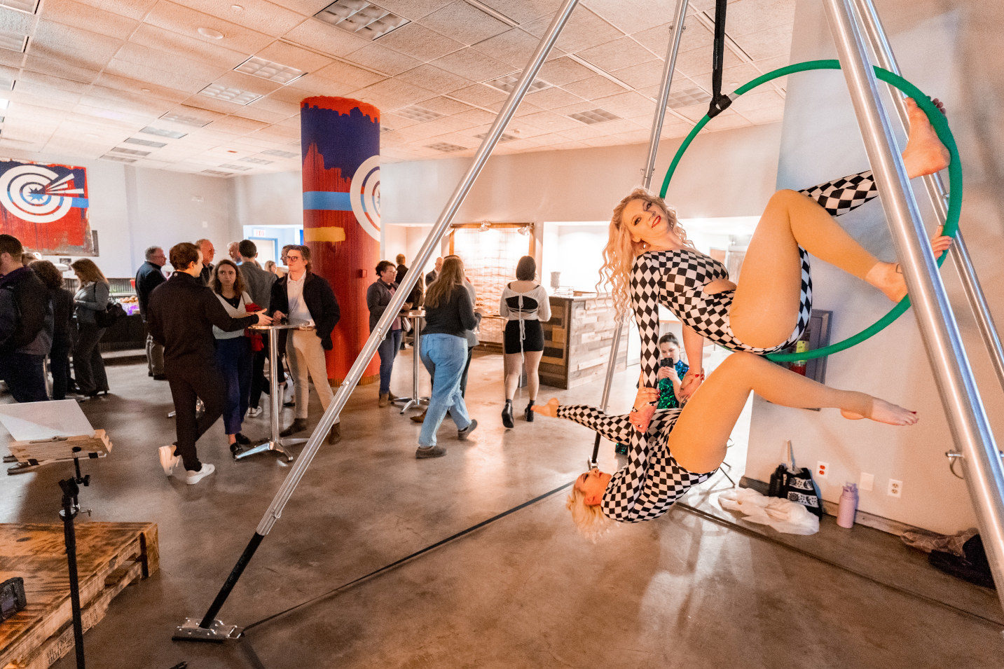 Photo of entertainers in the foreground while the party carries on behind them